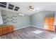 Bright bonus room with wood flooring and built-in shelves at 535 Valley Stream Dr, Geneva, FL 32732
