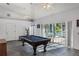 Game room with pool table, access to pool, and plenty of natural light at 535 Valley Stream Dr, Geneva, FL 32732