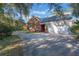 Two-car garage with a long driveway leading to the home at 535 Valley Stream Dr, Geneva, FL 32732