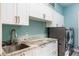 Laundry room with granite countertop, white cabinets and washer/dryer at 535 Valley Stream Dr, Geneva, FL 32732