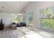 Open living room with kitchen and ample natural light at 535 Valley Stream Dr, Geneva, FL 32732