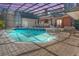 Inviting kidney-shaped pool with a covered patio and lounge chairs at 535 Valley Stream Dr, Geneva, FL 32732