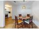 Round wooden dining table with four chairs, near the kitchen at 622 Yupon Ave, New Smyrna Beach, FL 32169