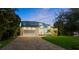 Two-story house with light yellow walls and a blue-gray roof at 73 Cunningham Dr, New Smyrna Beach, FL 32168