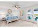 Bright main bedroom with water views, king bed, and private access to balcony at 73 Cunningham Dr, New Smyrna Beach, FL 32168