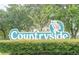 Countryside community sign with a butterfly emblem at 914 Fruitwood Pl, Port Orange, FL 32127