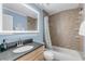 Clean bathroom with a shower/tub combo and granite countertop at 101 N Pine St # 7, New Smyrna Beach, FL 32169