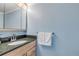 Clean bathroom with granite countertop and light blue walls at 101 N Pine St # 7, New Smyrna Beach, FL 32169