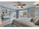 Main bedroom with private deck access and ceiling fan at 101 N Pine St # 7, New Smyrna Beach, FL 32169