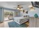 Spacious bedroom with access to private deck and ceiling fan at 101 N Pine St # 7, New Smyrna Beach, FL 32169