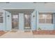Two-unit building entrance with gray doors and welcome mats at 101 N Pine St # 7, New Smyrna Beach, FL 32169