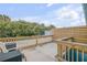 Relaxing rooftop deck with wooden railings and city views at 101 N Pine St # 7, New Smyrna Beach, FL 32169