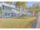 Row of light blue townhouses with a grassy yard at 101 N Pine St # 7, New Smyrna Beach, FL 32169