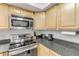 Stainless steel appliances and granite countertops in this updated kitchen at 101 N Pine St # 7, New Smyrna Beach, FL 32169