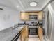 Updated kitchen featuring stainless steel appliances and wood cabinets at 101 N Pine St # 7, New Smyrna Beach, FL 32169