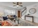 Spacious living room with a sofa, coffee table, and large TV at 101 N Pine St # 7, New Smyrna Beach, FL 32169