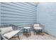 Cozy patio with wicker chairs and a small table at 101 N Pine St # 7, New Smyrna Beach, FL 32169