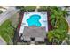 Community pool with lounge chairs and shaded seating area at 118 Grey Widgeon Ct, Daytona Beach, FL 32119