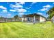 Screened patio and fenced backyard with a grassy area at 1331 Umbrella Tree Dr, Edgewater, FL 32132