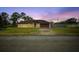 House exterior view at dusk, featuring a garage and lawn at 1331 Umbrella Tree Dr, Edgewater, FL 32132