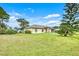 One-story house with a large front yard and lush green grass at 1331 Umbrella Tree Dr, Edgewater, FL 32132