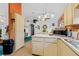 Updated kitchen with light wood cabinets, stainless steel appliances, and tile flooring at 1331 Umbrella Tree Dr, Edgewater, FL 32132