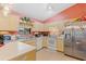 Galley kitchen with stainless steel appliances and an abundance of cabinetry at 1331 Umbrella Tree Dr, Edgewater, FL 32132