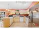 Well-equipped kitchen with wood cabinets, stainless steel appliances, and tile floors at 1331 Umbrella Tree Dr, Edgewater, FL 32132