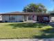 Single-story house with a neatly landscaped lawn and attached garage at 1493 Providence Blvd, Deltona, FL 32725