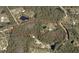 Aerial view of property showing home, pond, and surrounding land at 153 Ashby Cove Ln, New Smyrna Beach, FL 32168