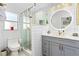 Clean bathroom, featuring gray vanity, a walk-in shower, and frameless glass at 1872 Mango Tree Dr, Edgewater, FL 32141