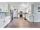 Modern kitchen with white cabinets, stainless steel appliances, and mosaic backsplash at 2003 12Th St, Edgewater, FL 32132