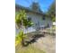 Small patio with table and chairs near the back door at 2017 Royal Palm Dr, Edgewater, FL 32141
