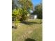 Large backyard with shed and tropical landscaping at 2017 Royal Palm Dr, Edgewater, FL 32141