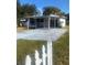 Front view of a white house with a carport and a yard at 2017 Royal Palm Dr, Edgewater, FL 32141