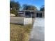 White house with a white picket fence and a long driveway at 2017 Royal Palm Dr, Edgewater, FL 32141