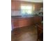 Kitchen with wood cabinets, double sink, and laminate flooring at 2017 Royal Palm Dr, Edgewater, FL 32141