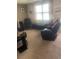 Living room with two armchairs and a bench in front of window at 2017 Royal Palm Dr, Edgewater, FL 32141