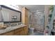 Bathroom with granite countertop, shower/tub combo, and linen shelving at 2259 Hawks Cove Cir, New Smyrna Beach, FL 32168