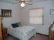 Cozy bedroom with double bed, ceiling fan, and window blinds at 2325 Date Palm Dr, Edgewater, FL 32141