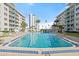 Relaxing pool with surrounding lounge chairs and condo building view at 2727 N Atlantic Ave # 2040, Daytona Beach, FL 32118