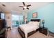 Bright bedroom with water views, king bed, and ceiling fan at 2801 S Ridgewood Ave # 1215, South Daytona, FL 32119