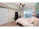 Bedroom with water views, king bed, and ceiling fan at 2801 S Ridgewood Ave # 1215, South Daytona, FL 32119