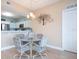 Bright dining area with glass table and four chairs, adjacent to kitchen at 2801 S Ridgewood Ave # 1215, South Daytona, FL 32119