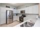 Modern kitchen with stainless steel appliances and white cabinets at 2801 S Ridgewood Ave # 1215, South Daytona, FL 32119