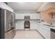 Modern kitchen with stainless steel appliances and white cabinets at 2801 S Ridgewood Ave # 1215, South Daytona, FL 32119
