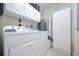 Bright laundry room with washer, dryer, and storage cabinets at 2801 S Ridgewood Ave # 1215, South Daytona, FL 32119