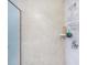 Beige tiled shower with shelf and shower caddy at 2801 S Ridgewood Ave # 1215, South Daytona, FL 32119