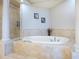 Bathroom with an oval soaking tub and walk-in shower at 2901 S Atlantic Ave # 603, Daytona Beach, FL 32118