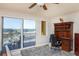 Bedroom with a workspace, balcony access, and scenic water views at 2901 S Atlantic Ave # 603, Daytona Beach, FL 32118